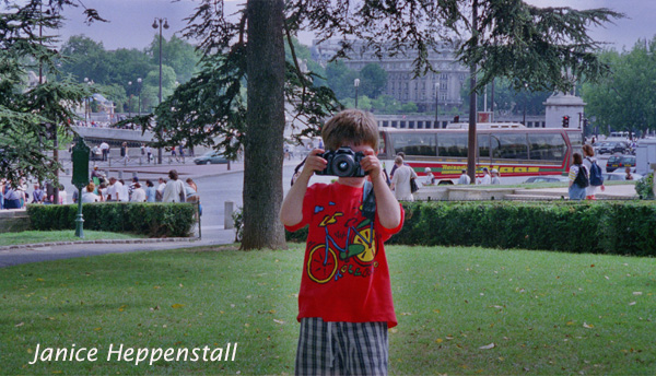 Small boy with camera, taking photograph