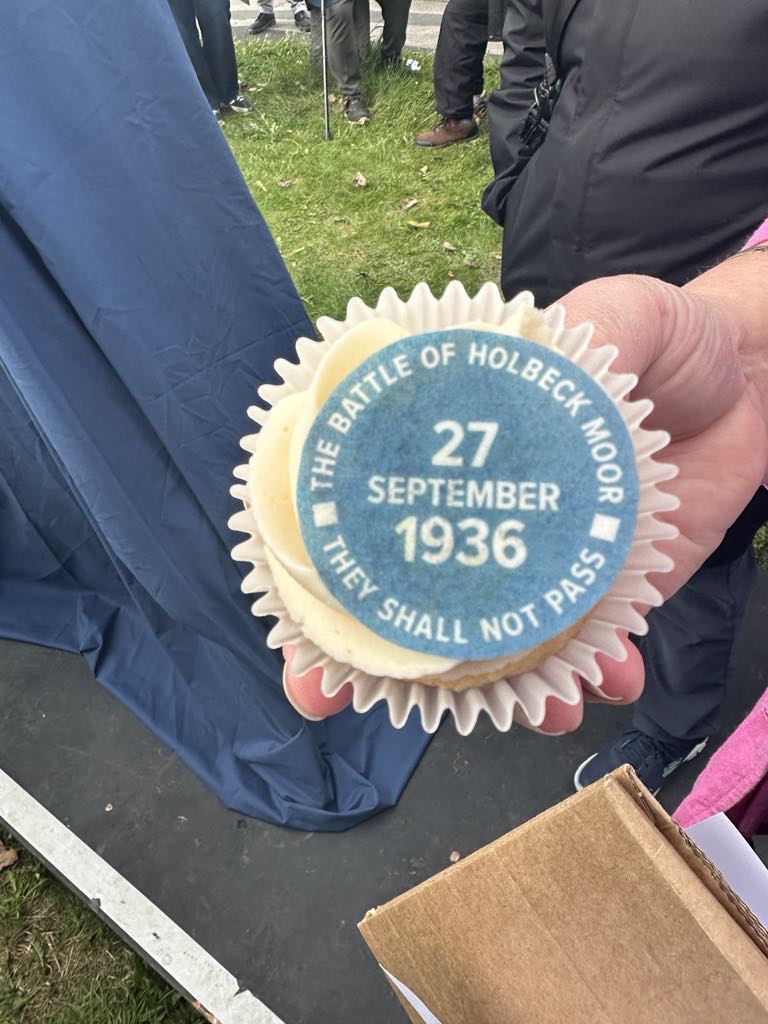 A cupcake featuring a 'blue plaque' decoration, including the words: 'The Battle of Holbeck Moor - 27 September 1936 - They Shall Not Pass'